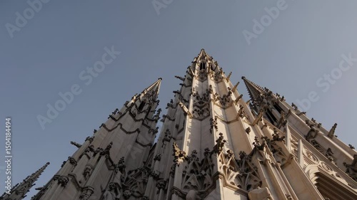 Gothic cathedral facade with detailed stone sculptures and dramatic vertical lines

