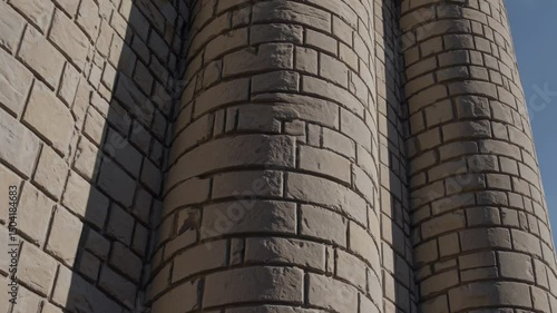 Close-up of Romanesque stone columns with rough texture and curved structure

