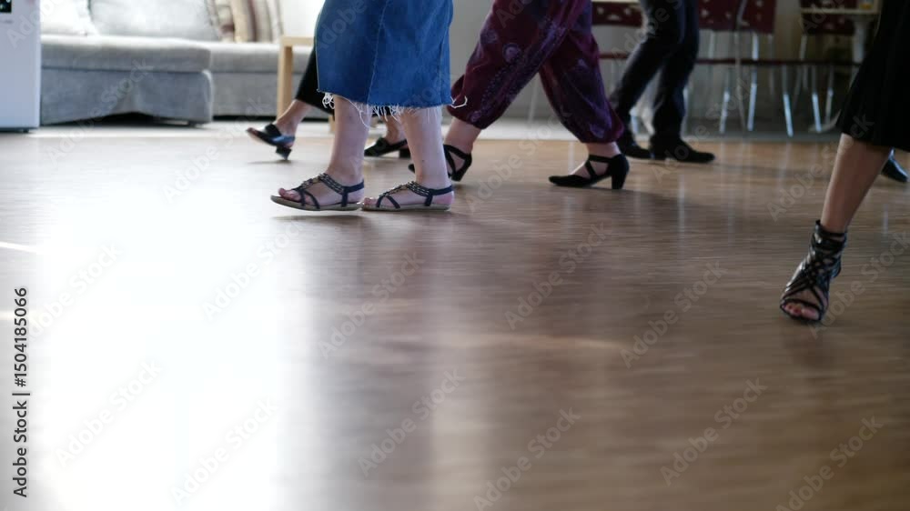 Low angle slow-motion of the feet of dancers while they are training in a dancing class Low angle slow-motion of the feet of dancers while they are training in a dancing class