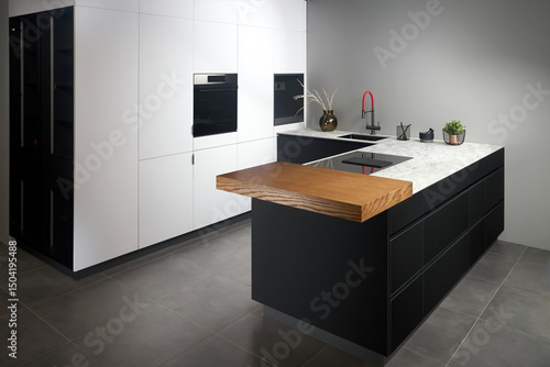 Tableau sur toile Upscale modern flat design loft kitchen with Induction cooker black glass hob with integrated hood or aspirating induction hob on marble light stoneware countertop, vase, sink and large cutting board