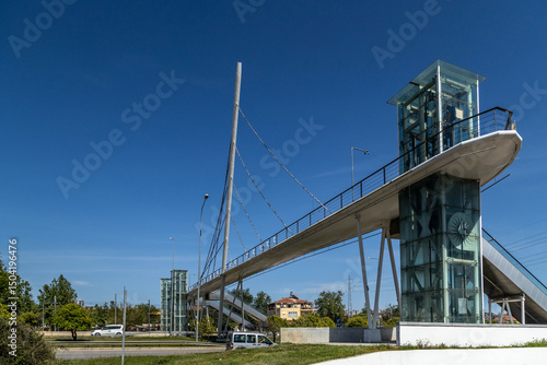 Photos Angled low shot of a modern cable-stayed pedestrian bridge with escalators and glass elevators in Fatih district