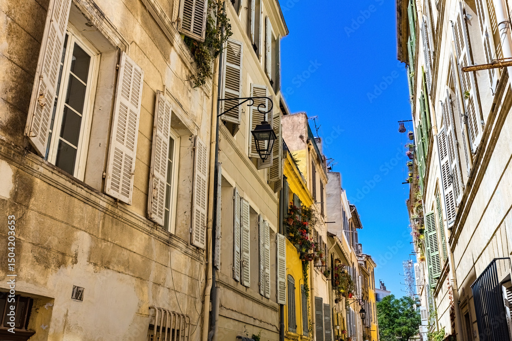 Fototapeta premium Old French houses narrow street in Le Panier area of Marseille, France