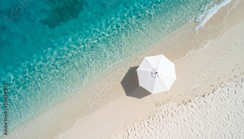 Breathtaking aerial view of a pristine tropical beach with crystal-clear turquoise water and a white umbrella providing shade. Perfect for travel and vacation themes!