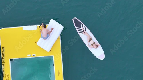 A young couple are enjoying seaside adventure aboard a yacht