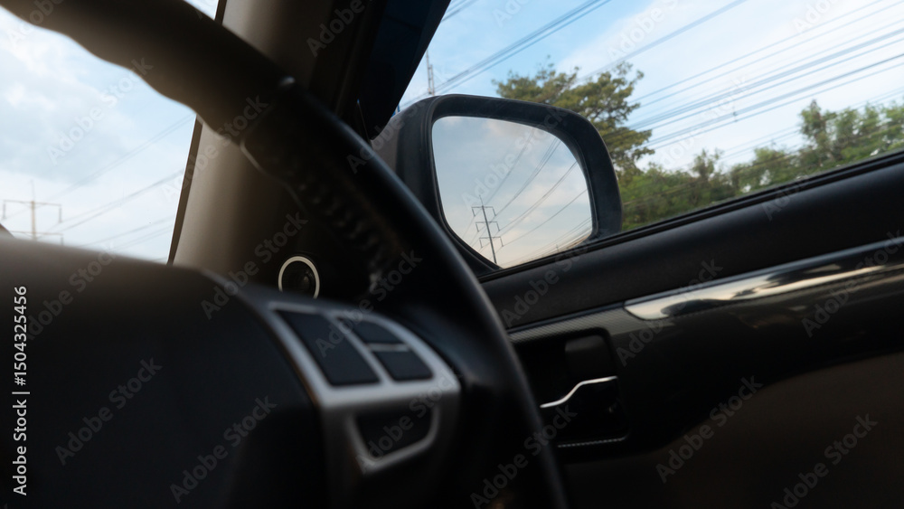 Fototapeta premium Internal car steering wheel control. Outdoor of trees and electic pole under blue sky.