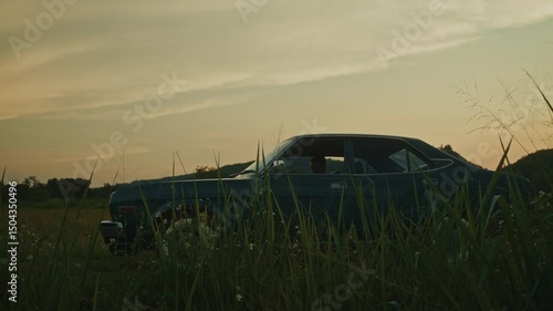 A Beautiful Vintage Car Set Against a Serene and Picturesque Landscape During Sunset