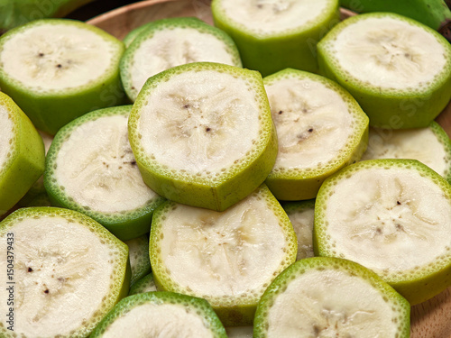 Sliced ​​bananas on a wooden plate