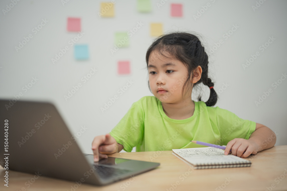 Young girl focused on online learning sitting at desk with laptop and notebook surrounded by colorful sticky notes highlighting remote education concept Young girl focused on online learning sitting at desk with laptop and notebook surrounded by colorful sticky notes highlighting remote education concept