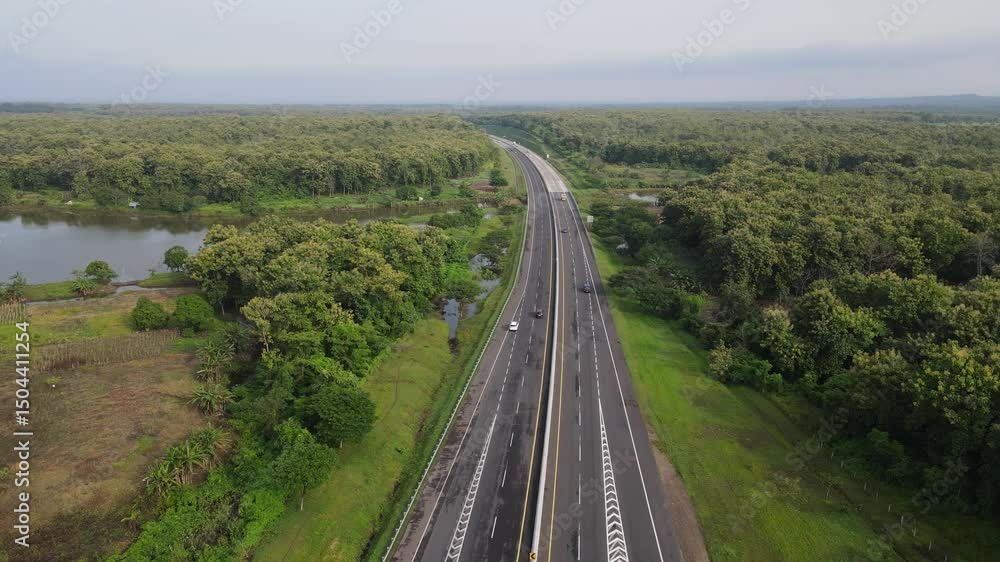 Aerial view of toll road that surrounded by nature in Java, Indonesia. Aerial view of toll road that surrounded by nature in Java, Indonesia.