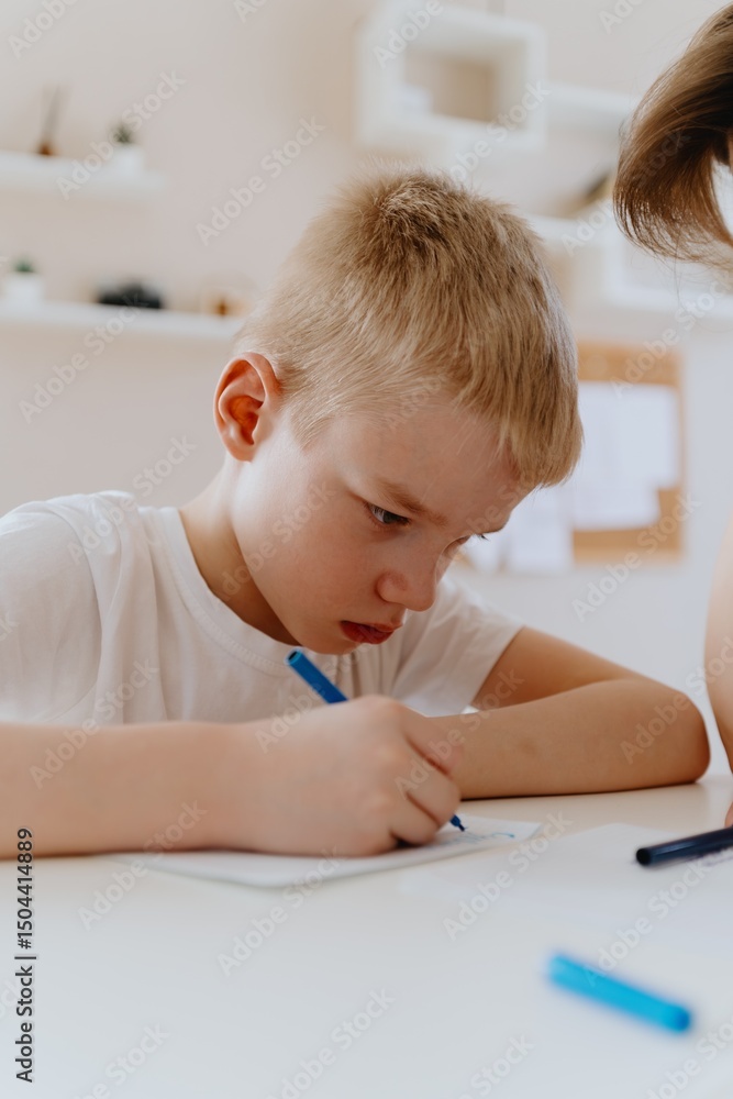 A loving mother and her son work together on homework at the kitchen table, symbolizing family support, education, and care. The scene highlights the importance of parental guidance A loving mother and her son work together on homework at the kitchen table, symbolizing family support, education, and care. The scene highlights the importance of parental guidance