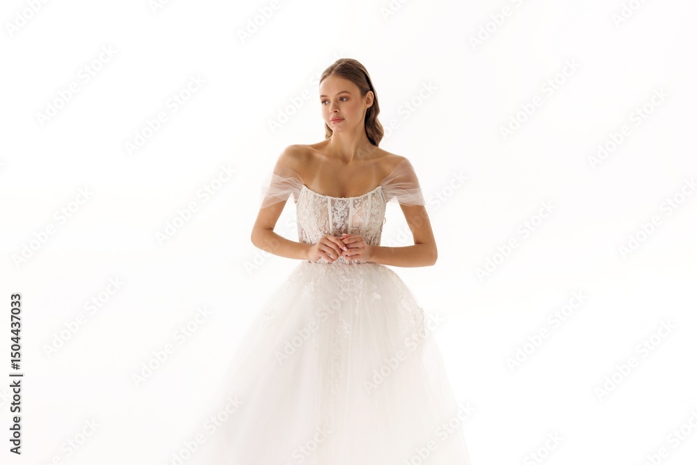 Elegant bridal model showcases delicate wedding gown in a minimalist studio setting during a fashion photoshoot Elegant bridal model showcases delicate wedding gown in a minimalist studio setting during a fashion photoshoot