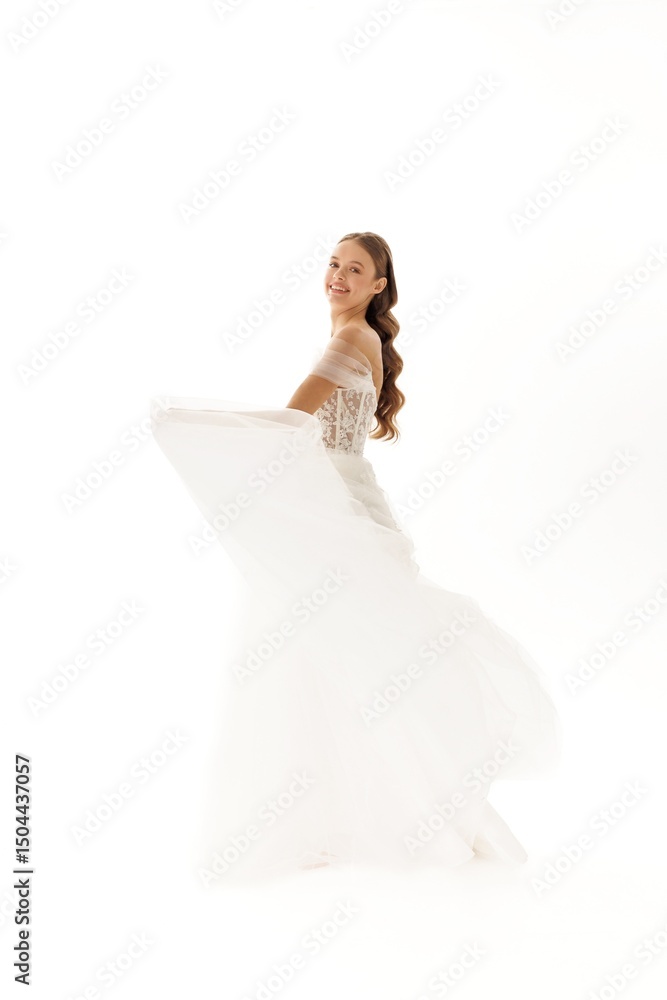 Bride twirls gracefully in elegant wedding gown on a bright white background during a photoshoot at sunset Bride twirls gracefully in elegant wedding gown on a bright white background during a photoshoot at sunset