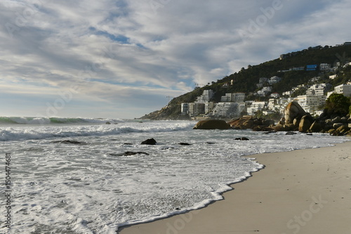 View of ocean waves and sandy beach - namely Boulders  beach in Cape Town South Africa
