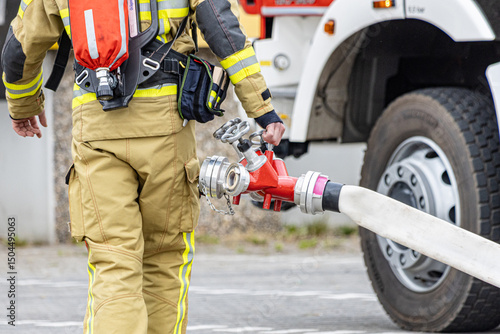 During a disaster protection exercise, the fire department and CBRN defense units train for chemical, biological, and radiological emergencies, using protective suits and decontamination gear.

