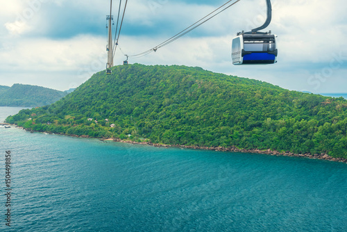 Cable car gondola gliding over turquoise sea and green tropical island. Longest Hon Thom cable car ride in the world on Phu Quoc island, Vietnam. Modern tourism technology and infrastructure