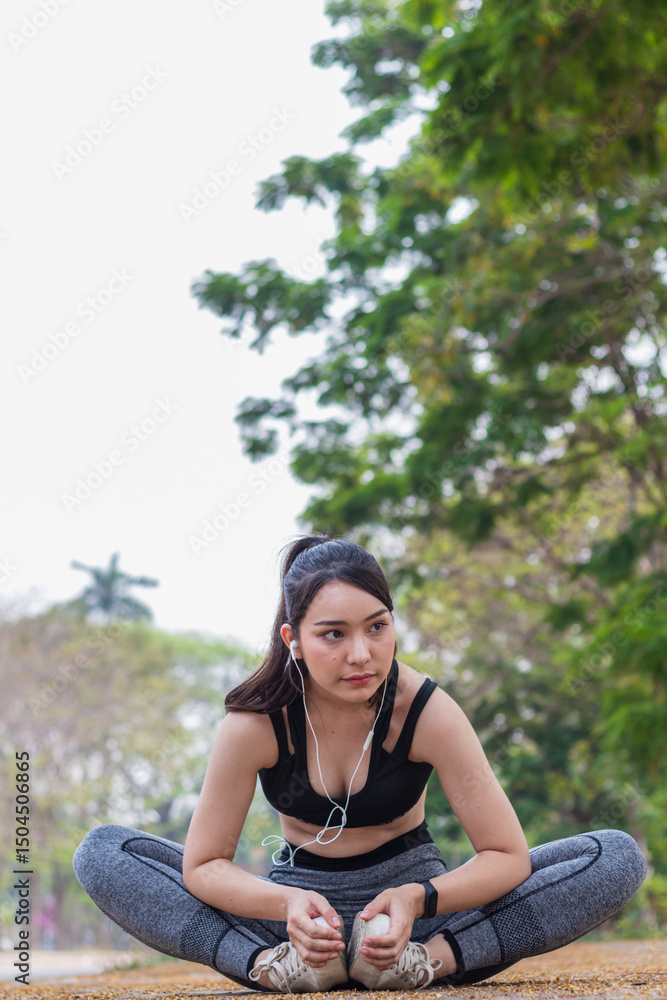 Beautiful Asian woman warming up her body to prepare her muscles for run to reduce muscle injuries during run exercise. Beautiful Asian woman stretching her muscles to prepare for run . Beautiful Asian woman warming up her body to prepare her muscles for run to reduce muscle injuries during run exercise. Beautiful Asian woman stretching her muscles to prepare for run .