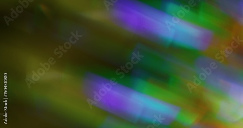 Colorful flare. Blurred glimmering texture. Green purple yellow lens glow radiance on dark black art background.