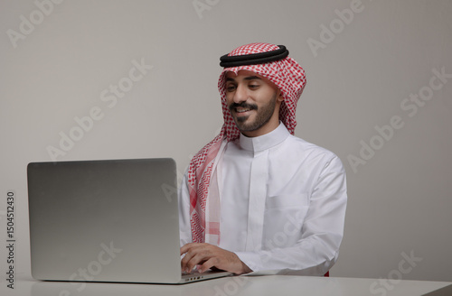 Confident Saudi man in traditional attire working on a laptop at a desk in various expressions—smiling, surprised, thoughtful—perfect for business, tech, or remote work themes.