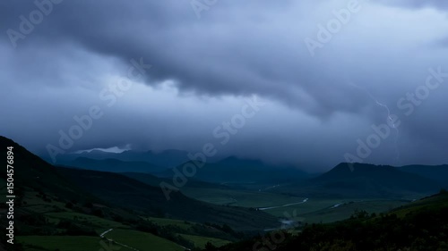 Stormy landscape with lightning over rolling hills