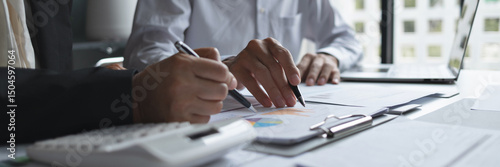 Photos Business administrator evaluating marketing and sales data for improved business