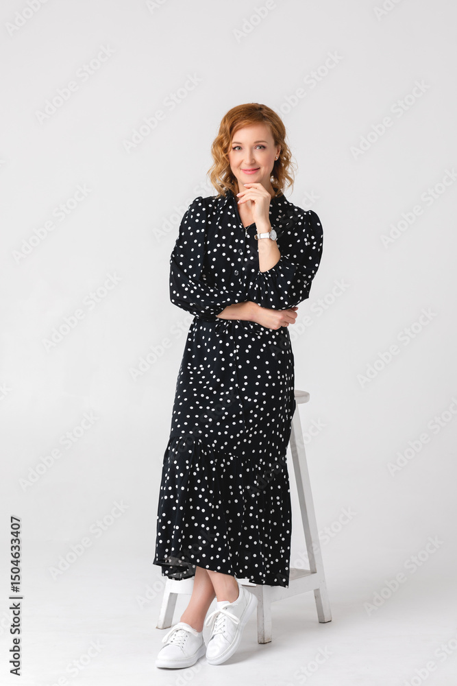 Beautiful young girl in a dark dress on a white background in a photo studio. Psychologist. Business photo. Beautiful young girl in a dark dress on a white background in a photo studio. Psychologist. Business photo.