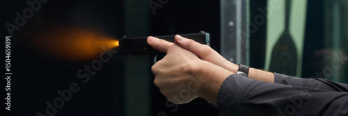 Behang Close up view of person discharging a firearm inside an indoor shooting range