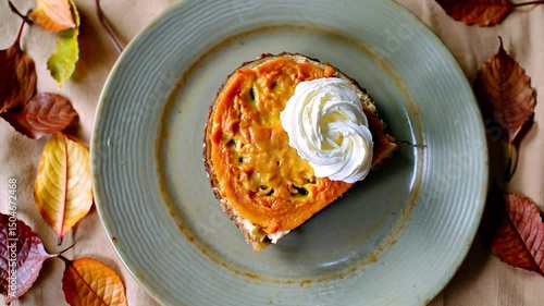 Pumpkin Pie Slice with Cream on Autumn Background