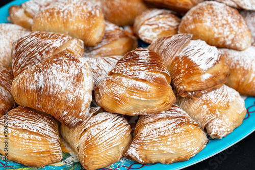 Fototapeta Naklejka Na Ścianę i Meble -  Many sfogliatella cakes on street market. Sfogliatelle puff pastry, naples bakery