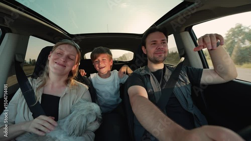 Family with dog car travel on road in sunset light, car interior view