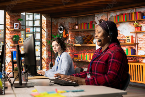 Cuadro en lienzo Call center agent laughing at funny joke while talking with customer in office