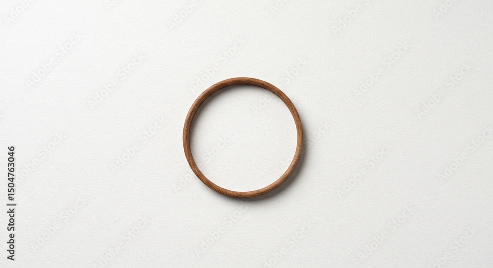a wooden ring on a white surface a wooden ring on a white surface