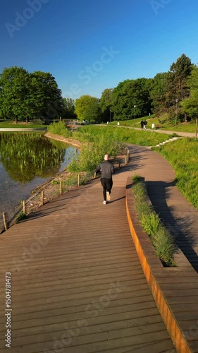 Morning Fitness Jog in Warsaw Park – Cinematic Vertical Drone Clip