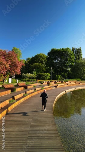 Healthy Lifestyle – Man Running by Lake in Warsaw Park, Vertical Aerial View