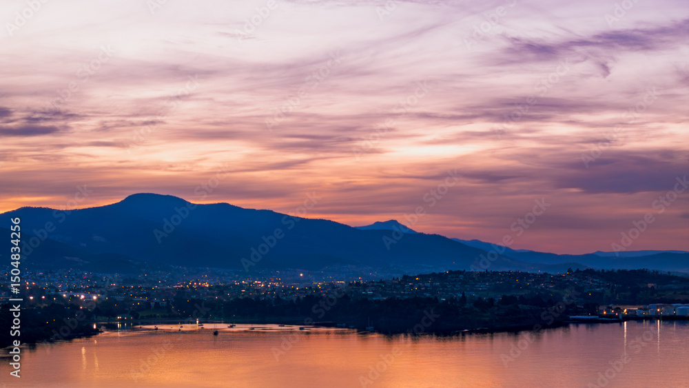 Sunset Over Hobart, Tasmania – Evening Cityscape with Mountains and Water Reflections Sunset Over Hobart, Tasmania – Evening Cityscape with Mountains and Water Reflections