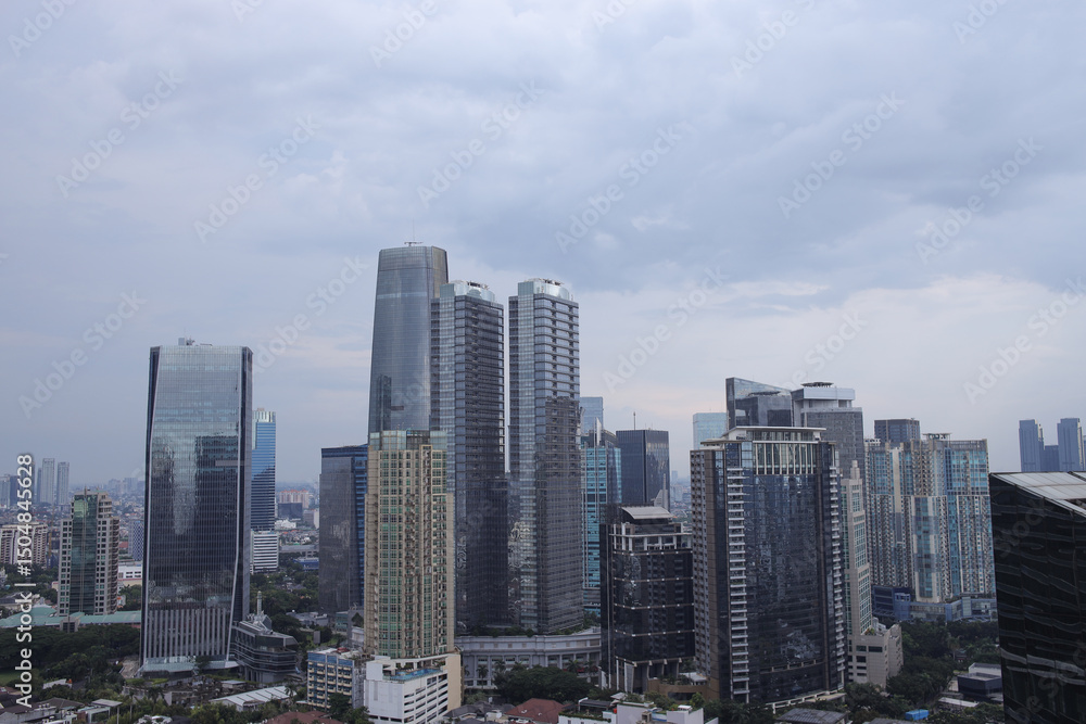 Fototapeta premium High Angle View Of City Skyline With Modern High Rise Buildings Under A Cloudy Sky