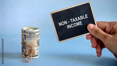 a hand holding notification board written with 'non taxable income' with dollar money beside it.