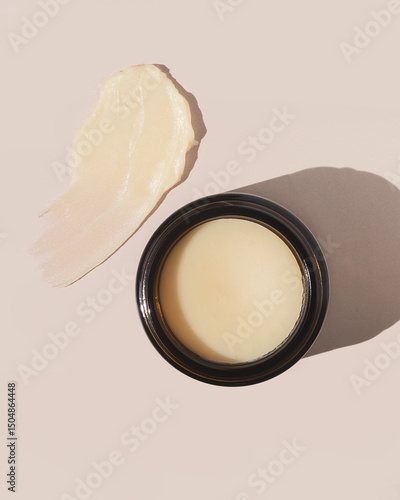 Natural and organic beef tallow balm on tan background with product texture