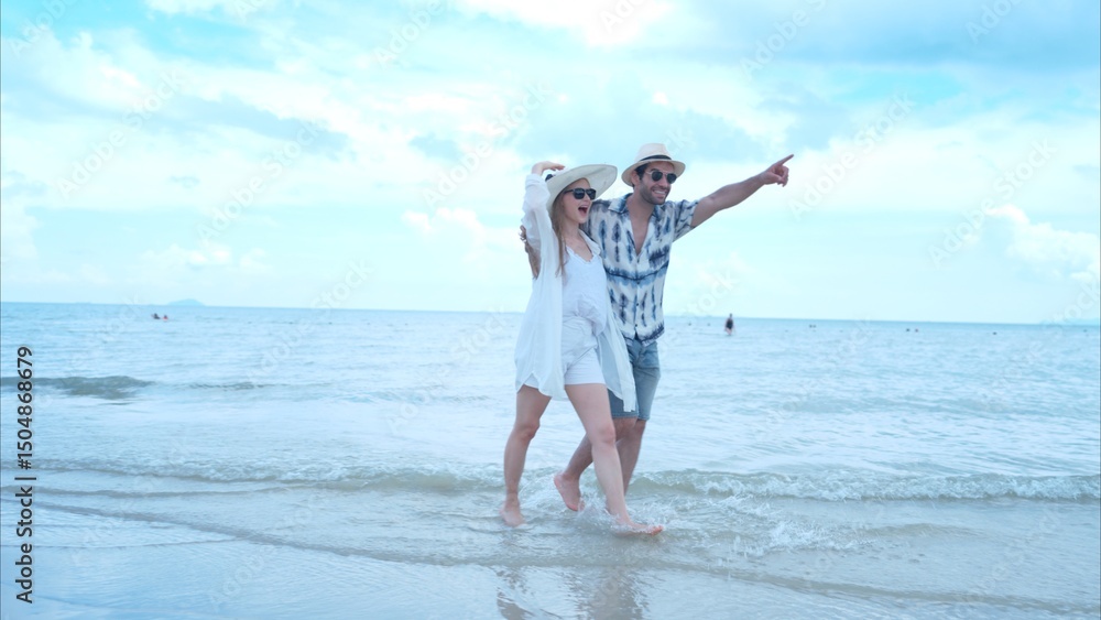 Young couple on vacation on a white sandy beach, clear sky and sea Young couple on vacation on a white sandy beach, clear sky and sea
