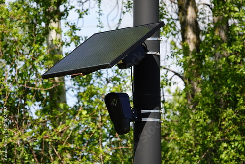 Flock safety police law enforcement license plate reader set up outside to help catch vehicle speeders.