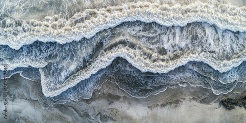 Aerial view of waves creating mesmerizing patterns as they meet the shoreline