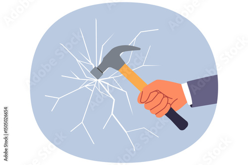 Glass breaks from blow from hammer held by hand of man trying to destroying unnecessary mirror partition. Concept of destroying barrier or vandalism during office robbery through window