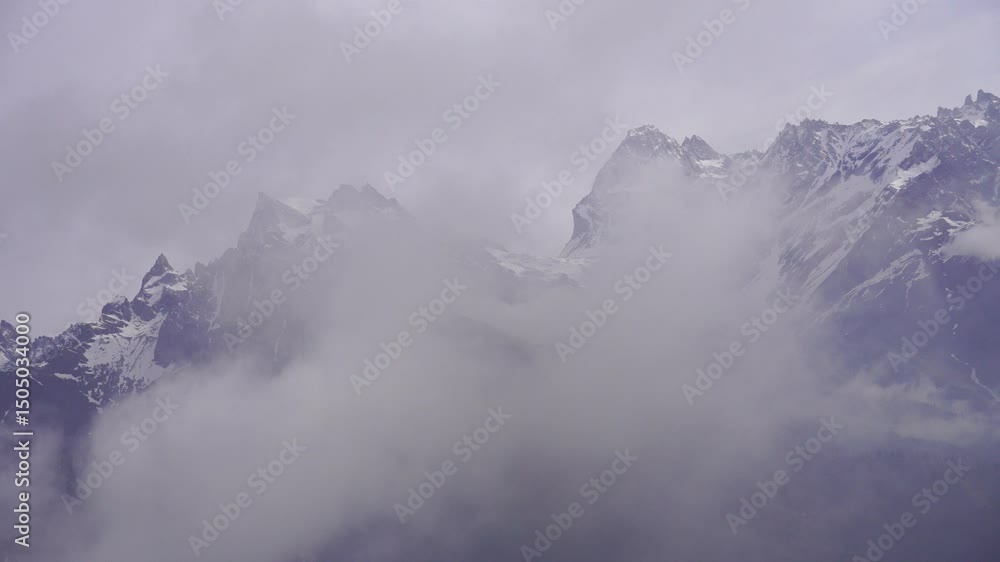 Snowy mountain peaks hidden in thick clouds. Snowy mountain peaks hidden in thick clouds.