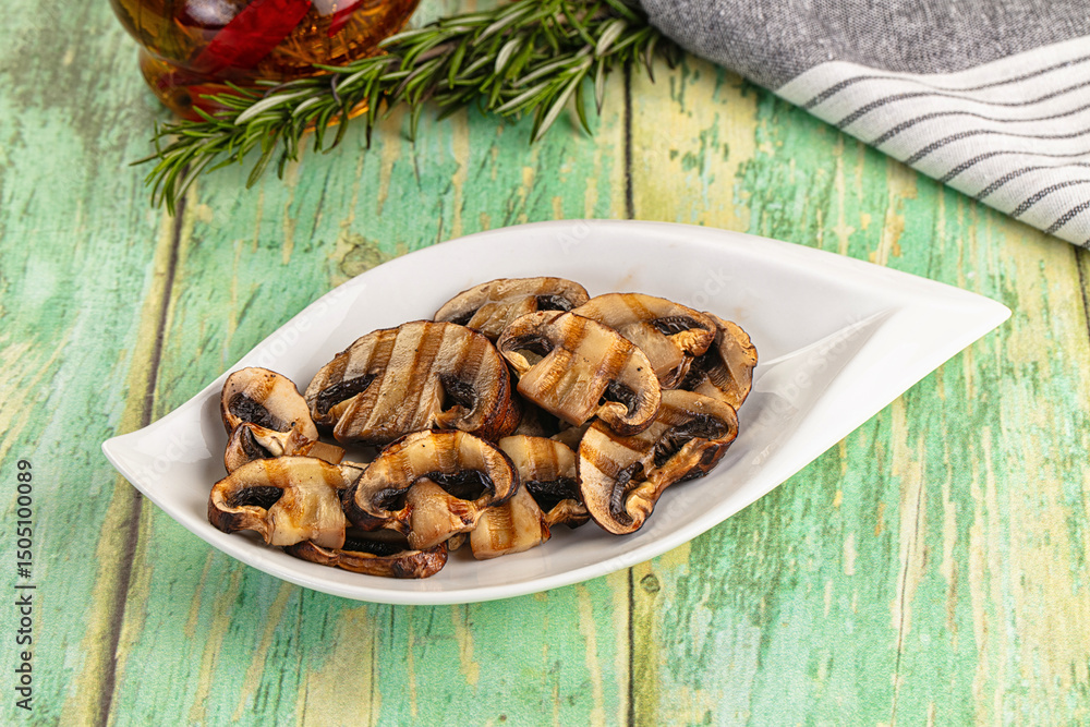 Fototapeta premium Tasty hot grilled champignon mushrooms