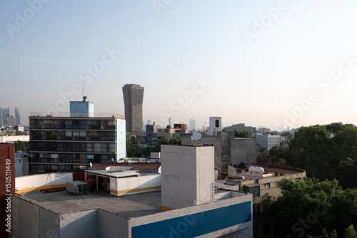 Aerial perspective of Mexico City rooftops, diverse architecture, clear sky, and modern skyline, perfect for business, cityscape, and editorial use in urban themes.