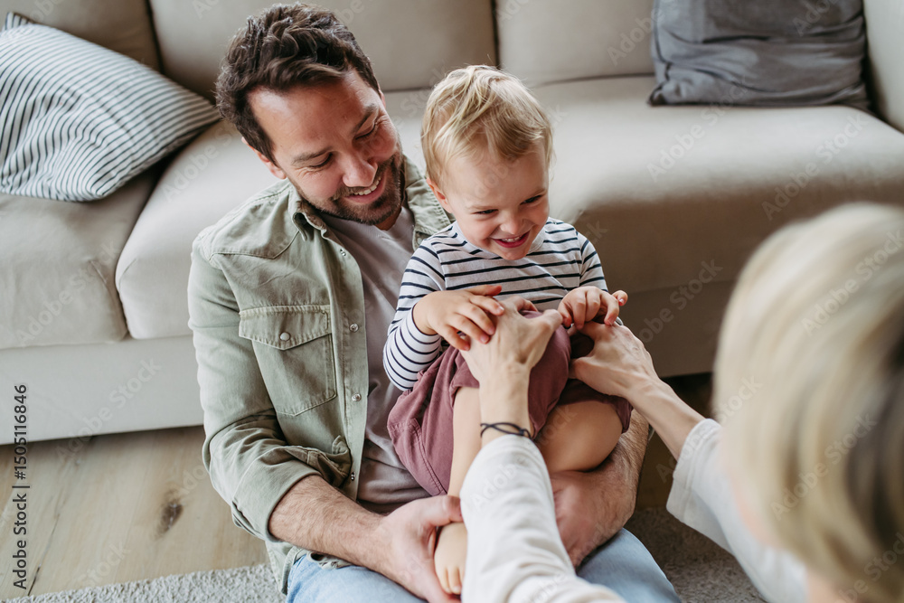 © Halfpoint - Happy family playing together at home.