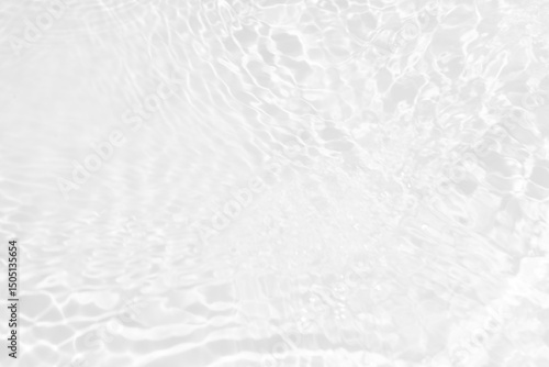 White water with ripples on the surface. Defocus blurred transparent white colored clear calm water surface texture with splashes and bubbles. Water waves with shining pattern texture background.