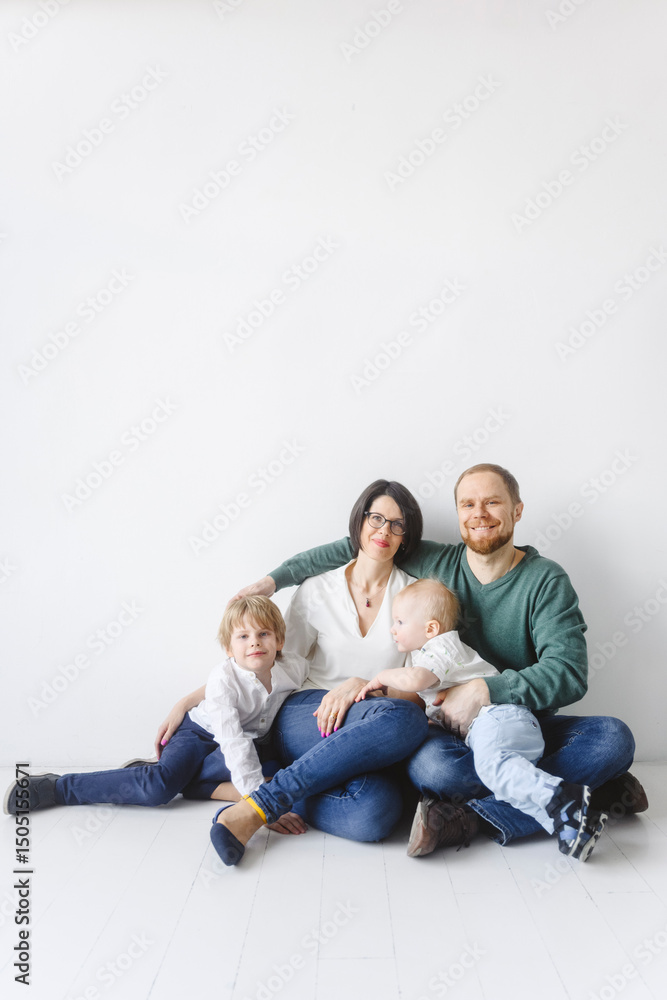 Family sitting together indoors on a white background Family sitting together indoors on a white background