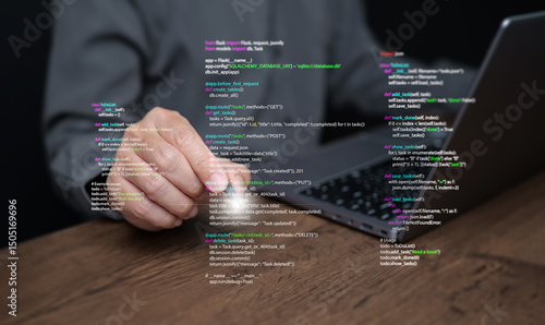 Hands of a programmer types on a laptop displaying programming code, symbolizing coding tech, software development, web applications. IT solutions, and digital technology