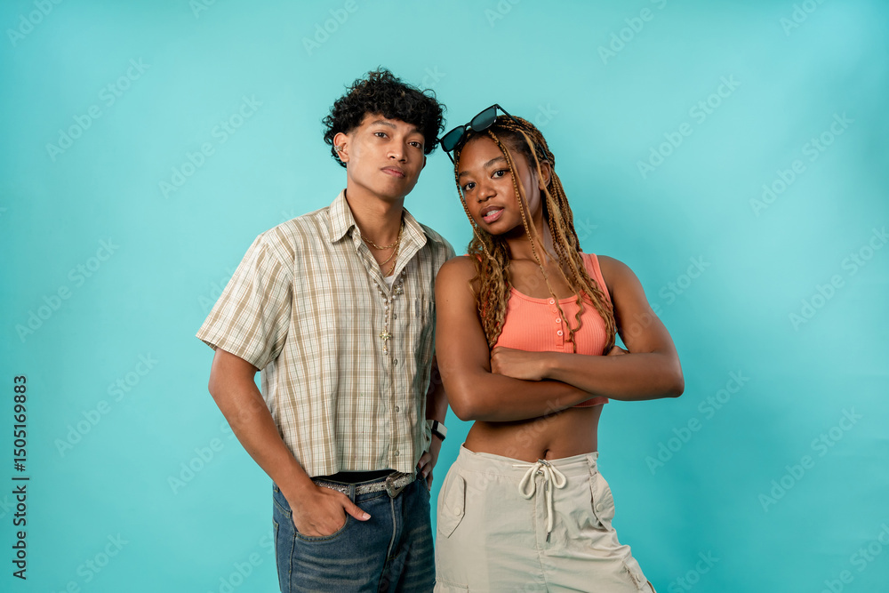 Naklejka premium Portrait of young African American couple posing on isolated blue screen. 