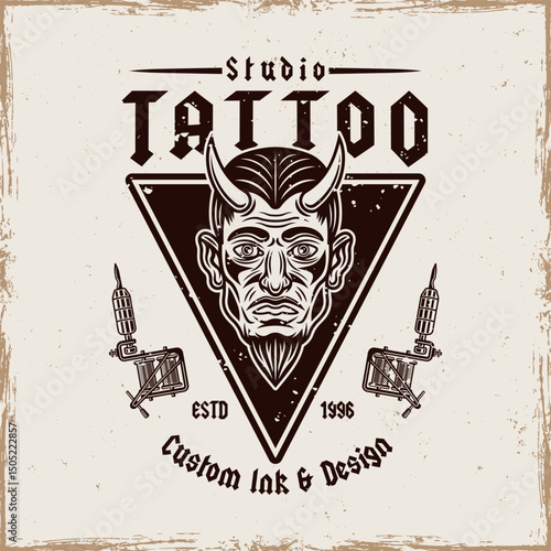Vintage tattoo studio emblem with devil man head and tattoo machines. Classic vector illustration in retro style, perfect for tattoo designs, apparel prints, and branding
